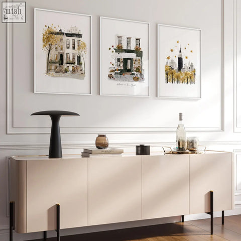 Beige sideboard with sleek minimalist design and black legs below autumn in new york living room wall art set of 3