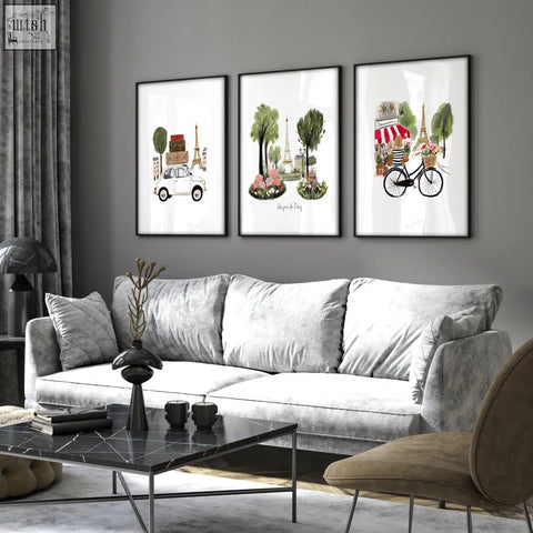 Three framed paris-themed travel wall art prints featuring eiffel tower hang above the living room sofa