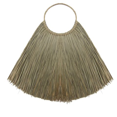 Beige straw fringe handbag with circular top handle next to large natural seagrass fan wall decor for boho wall decor
