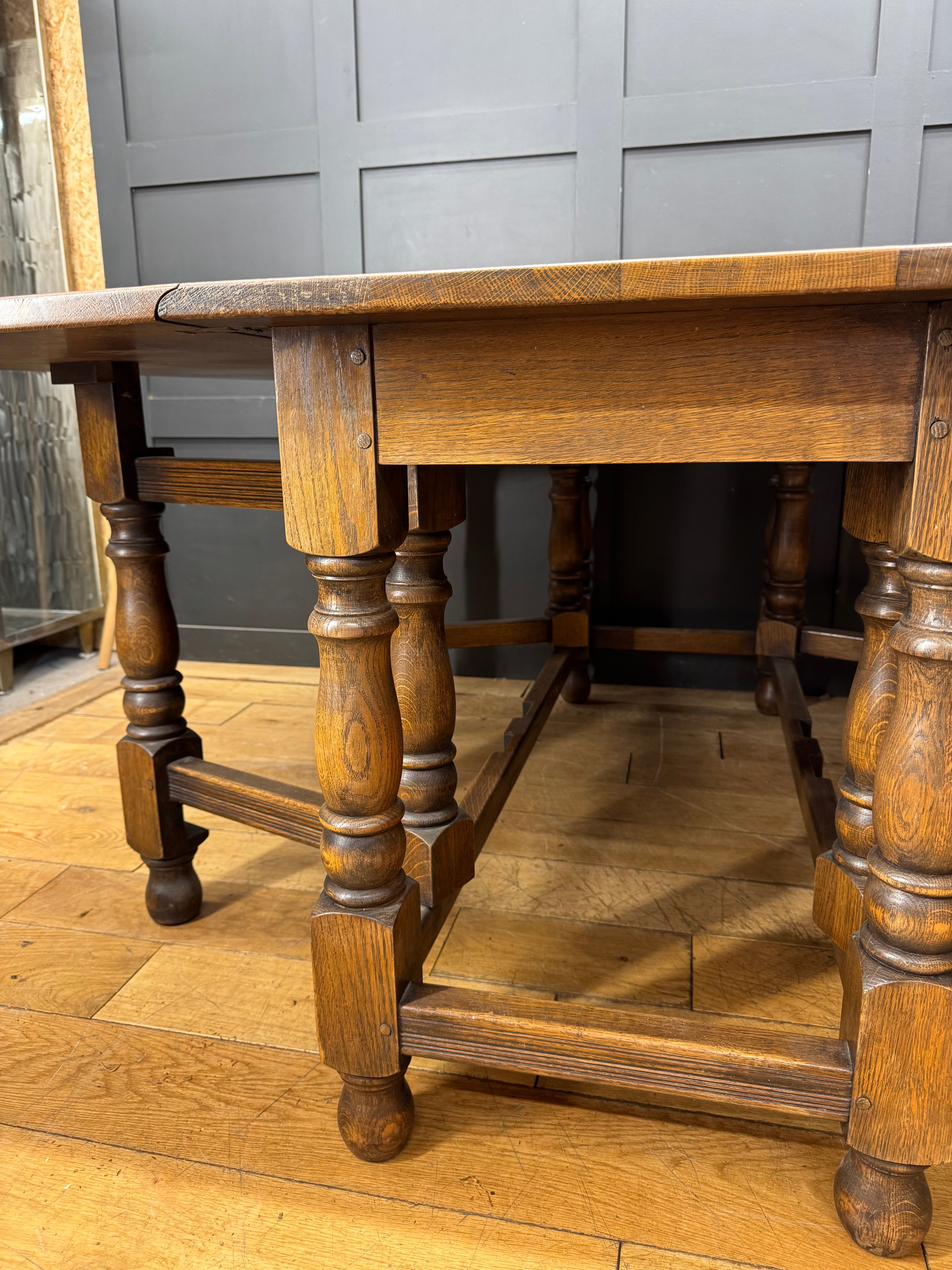 Large solid oak gateleg dining table with turned legs and a warm rustic finish perfect for kitchen or dining room