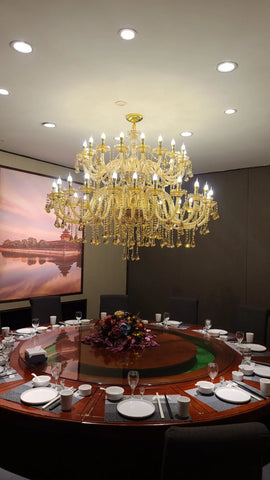 A large villa crystal chandelier with golden metalwork and hanging chain diameter 120cm*height above dining table
