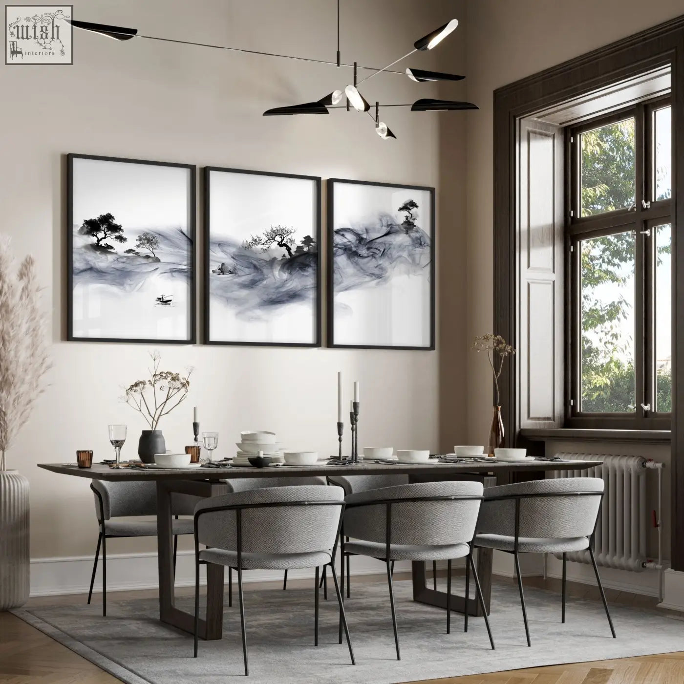 Three framed black-and-white ink wash landscape wall art prints hang above a dining room table in japandi style