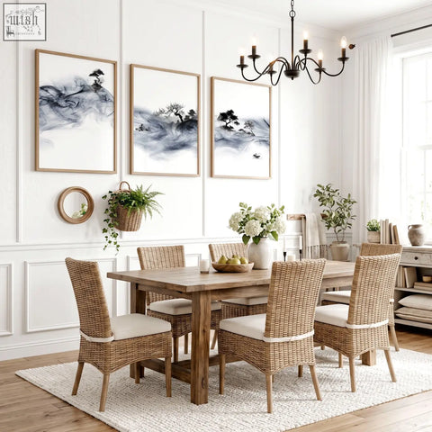 Woven wicker dining chairs with cream cushioned seats paired with blue japandi ink wash dining room wall art set of 3