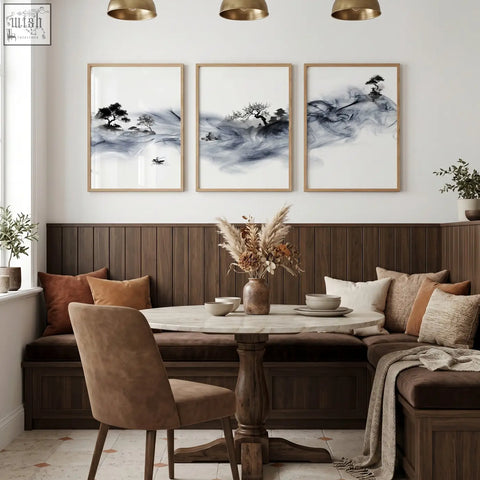 Round marble-top dining room table with dark wood pedestal base paired with blue japandi ink wash wall art set of 3
