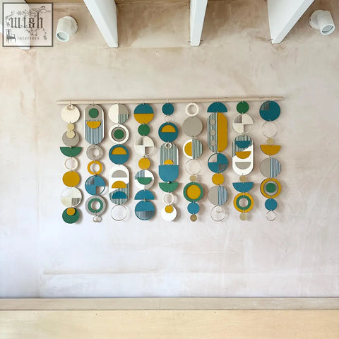 Large wall art wood geometric wall hanging with teal mustard green white and gray stripes for over the bed decor