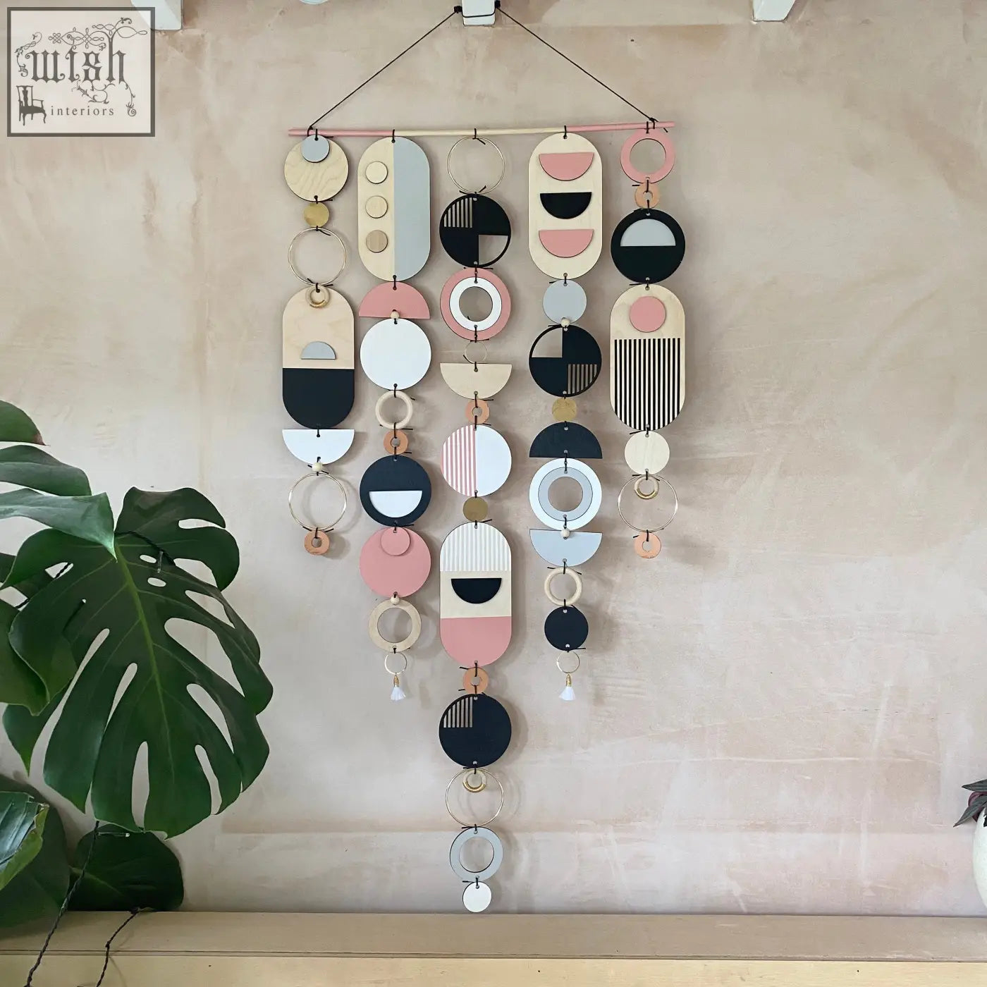 Large wall art hand painted with pink geometric wooden shapes in pastel, black, white, and natural tones for minimal decor
