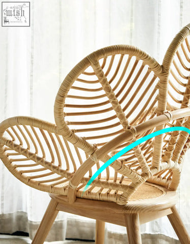 A light beige rattan larkin lounge chair with a curved petal backrest offering tropical elegance and financing options