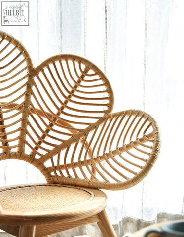 A light brown larkin lounge chair with rattan leaf-shaped backrest and natural fiber seat perfect for tropical elegance offers financing