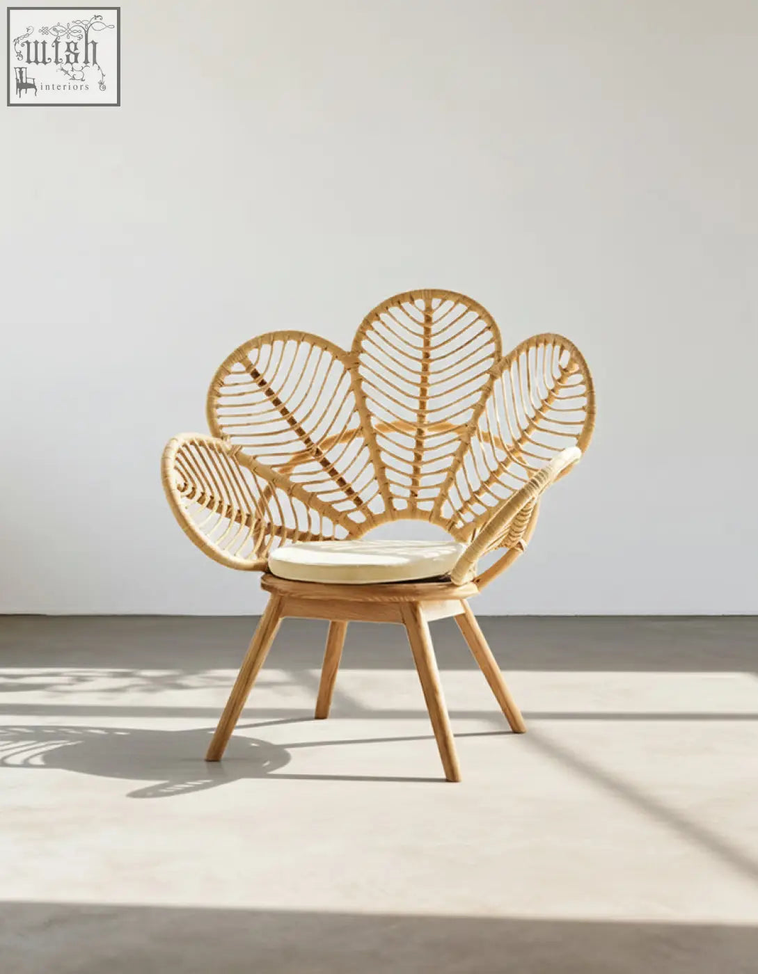 Larkin lounge chair light brown rattan armchair with leaf-shaped back cream cushion offering tropical elegance and financing