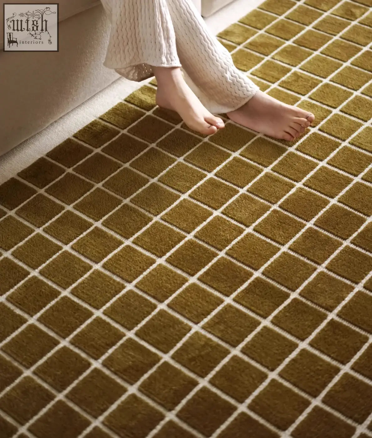 Olive green mosaic patterned lattice living room rug with cream grid lines perfect for under a coffee table set