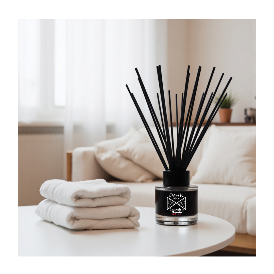 Black reed diffuser with glass bottle and laundry bombs label featuring fragrance oil for fresh laundry scent
