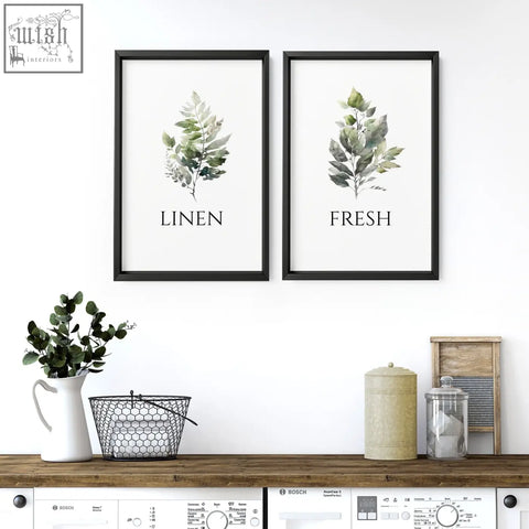 Two black-framed green foliage art prints with linen and fresh text perfect for laundry room art wall decor