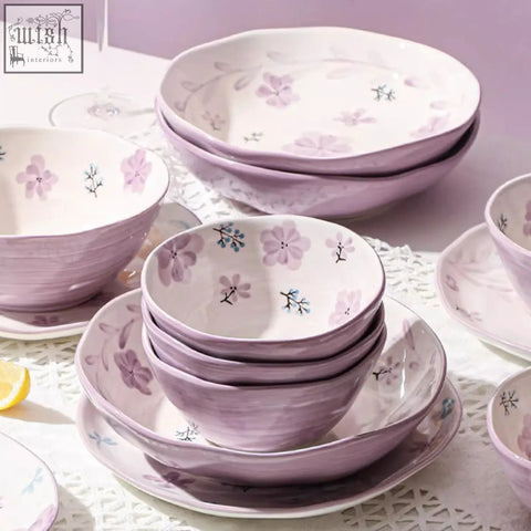 A delicate lavender ceramic layla orchid dining set with hand-painted pink and blue floral motifs on a matte surface