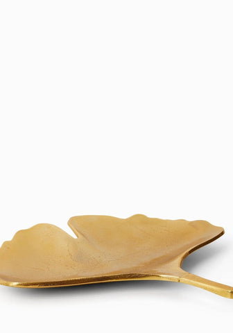 Le grande ginko leaf metallic gold tray shaped like a ginkgo leaf with a smooth reflective surface and slim stem handle
