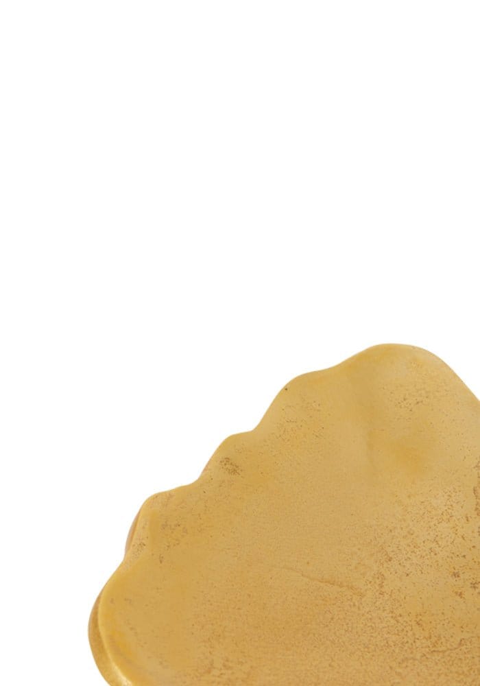 A smooth golden-yellow ceramic dish with scalloped edges from le grande ginko leaf collection