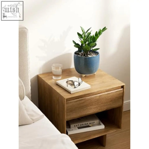 Light wood nightstand with clean lines holding blue ceramic plant pots with silicon plug for indoor plants