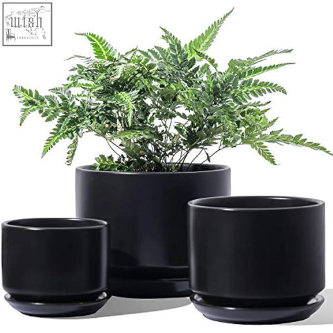Set of three sleek black ceramic planters with mesh pads and drainage holes perfect for indoor use and gifts