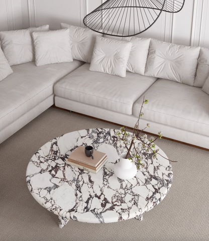 Leanna coffee table with a round white and black marble top and slender legs stylish round coffee table design