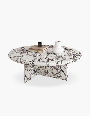 Leanna coffee table with a sleek oval white and black marble top and matching sculpted legs for stylish round coffee use