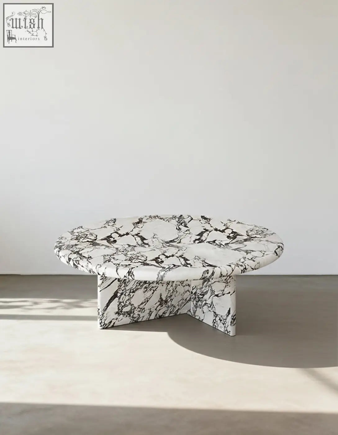 Leanna coffee table featuring a sleek round coffee table design with a white and black marble top and base