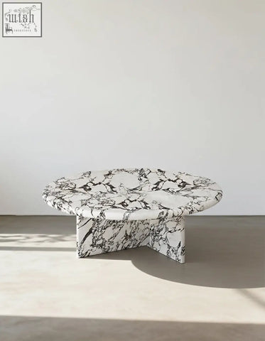 Leanna coffee table featuring a sleek round coffee table design with a white and black marble top and base