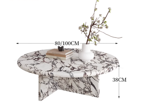 Leanna coffee table is a sleek round coffee table with a white and black marble patterned top and pedestal base