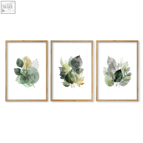 Set of three leaves print botanical wall art with warm gold-toned green and gray leaves in light wood frames