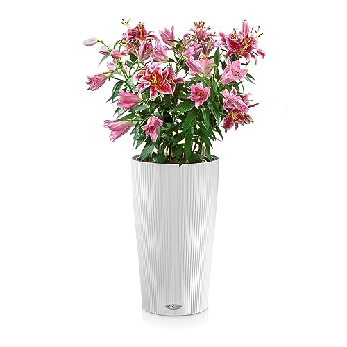 A tall white lechuza cilindro color plastic planter with water level indicator holding pink lilies and green foliage