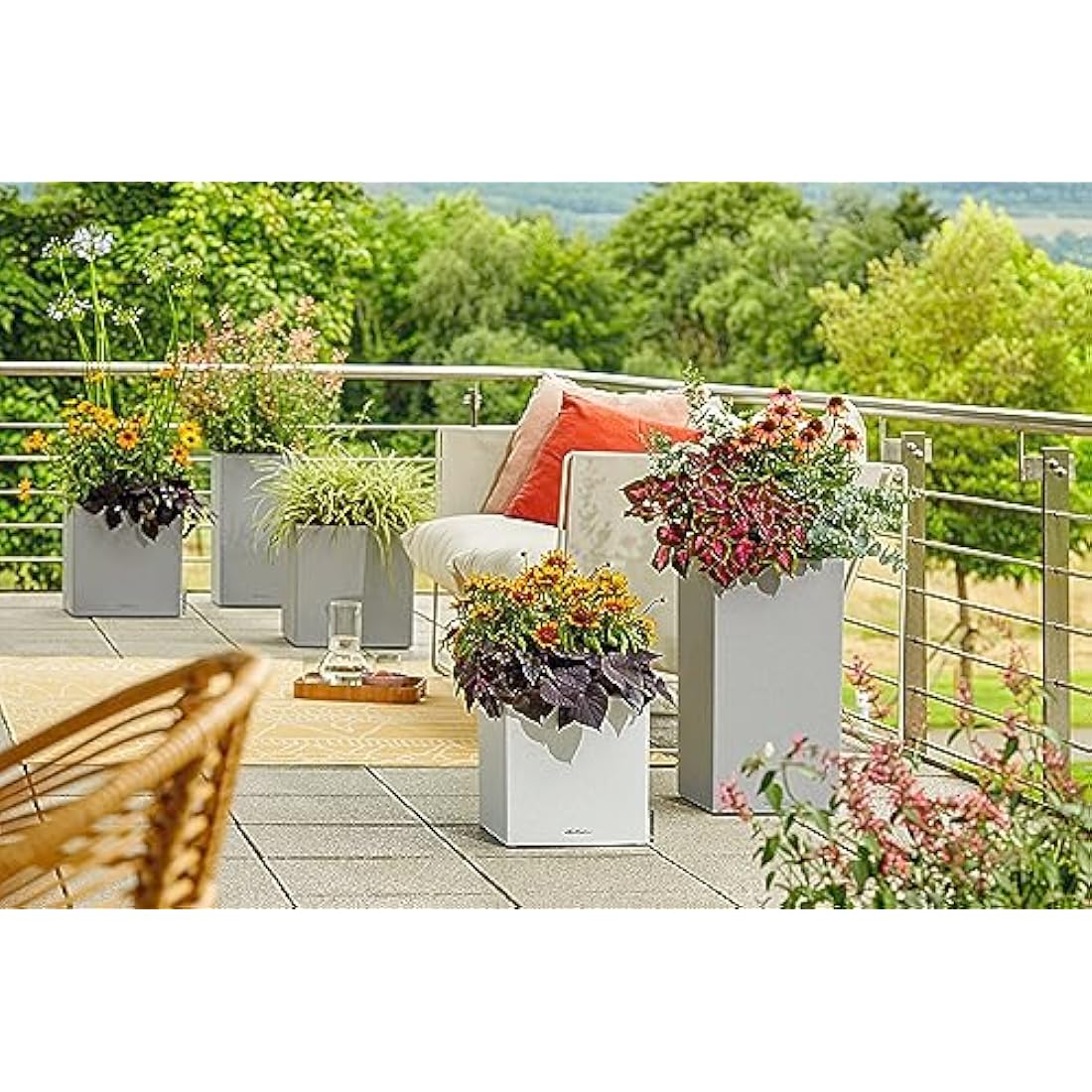 Modern canto stone plant pot in stone grey plastic with self watering and drainage hole featuring vibrant plants