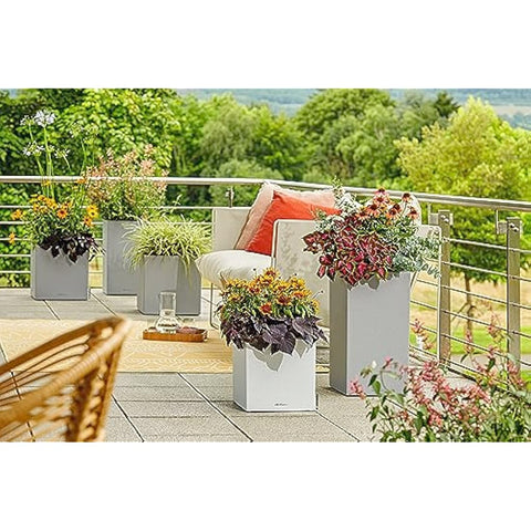 Modern canto stone plant pot in stone grey plastic with self watering and drainage hole featuring vibrant plants