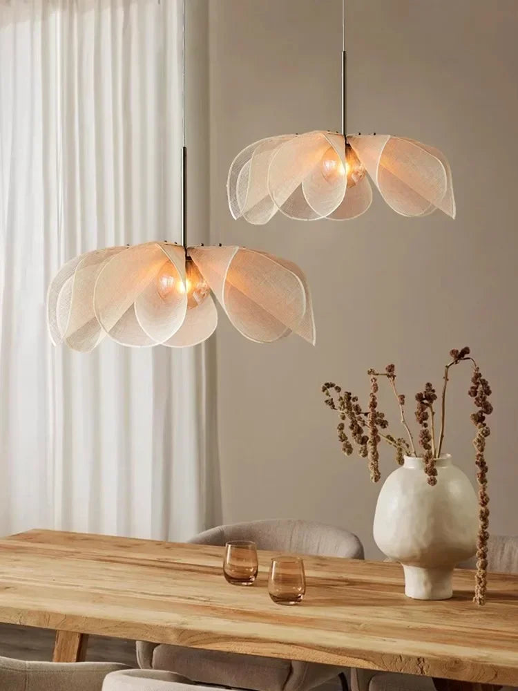 Delicate white translucent led flower pendant light with warm bulbs suspended on black rods for living room use