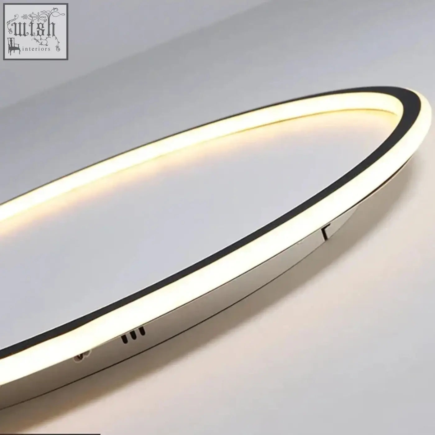 Modern oval shaped led mirror with sleek chrome frame and warm lighting complements black white ring flush mount chandelier