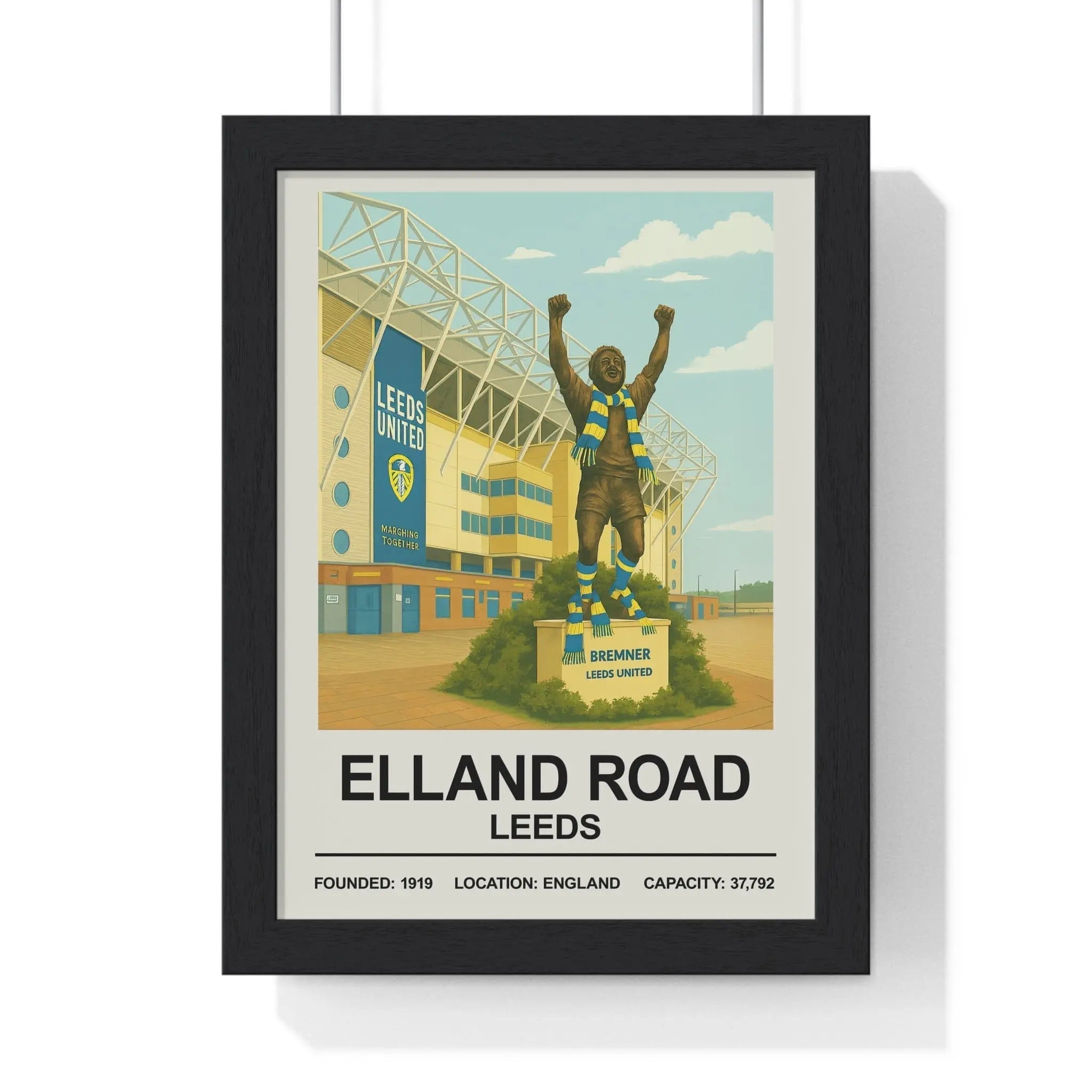 Black-framed Leeds Elland Road stadium print with vintage illustration and Bremner statue in blue and yellow colors