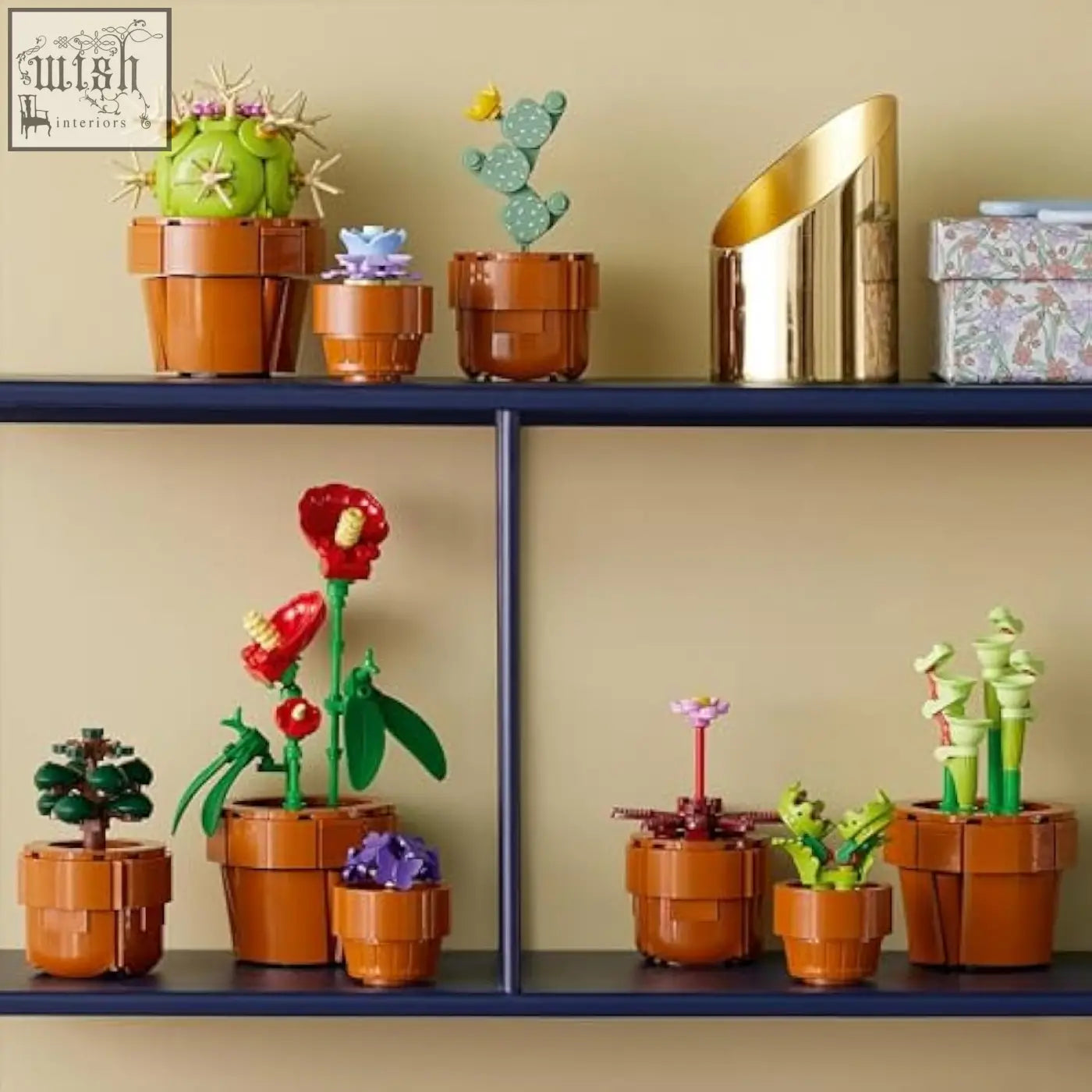 A vibrant red lego botanicals tiny flower with green leaves and yellow center in an orange terracotta-style pot