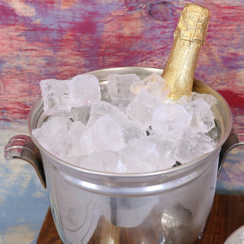 Lehal champagne bucket set with gold champagne bottle in silver ice bucket filled with clear chunky ice cubes