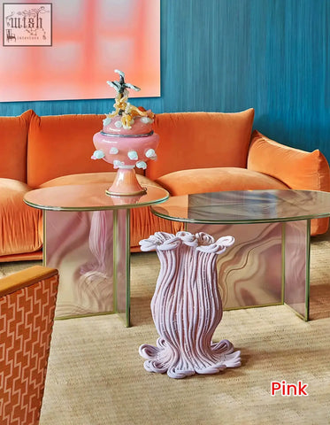 Leila coffee table features a pink glass coffee table with a round nesting design and a textured ribbed surface
