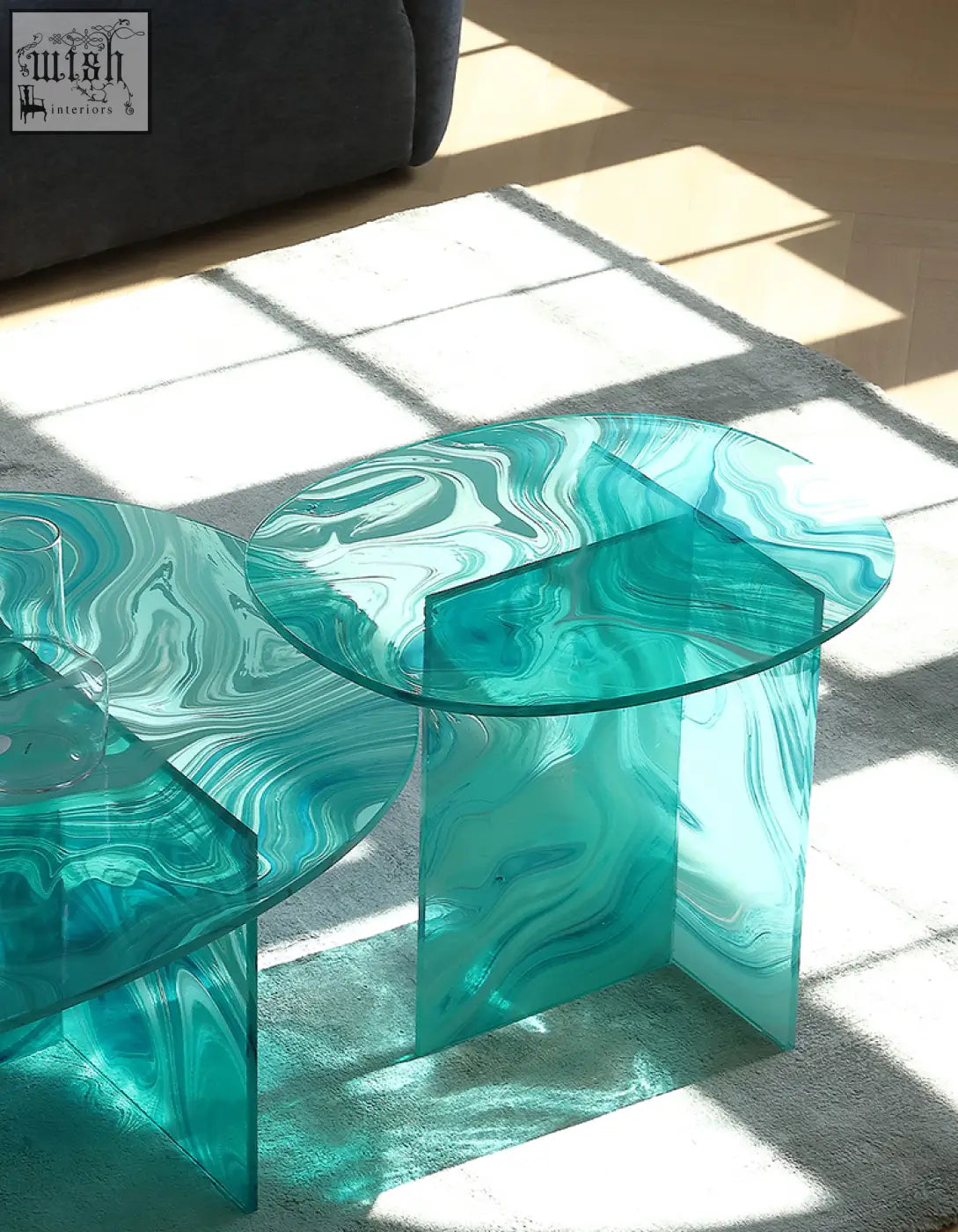 Teal marbled glass coffee table with geometric translucent bases and round nesting green glass tops