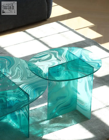 Teal marbled glass coffee table with geometric translucent bases and round nesting green glass tops