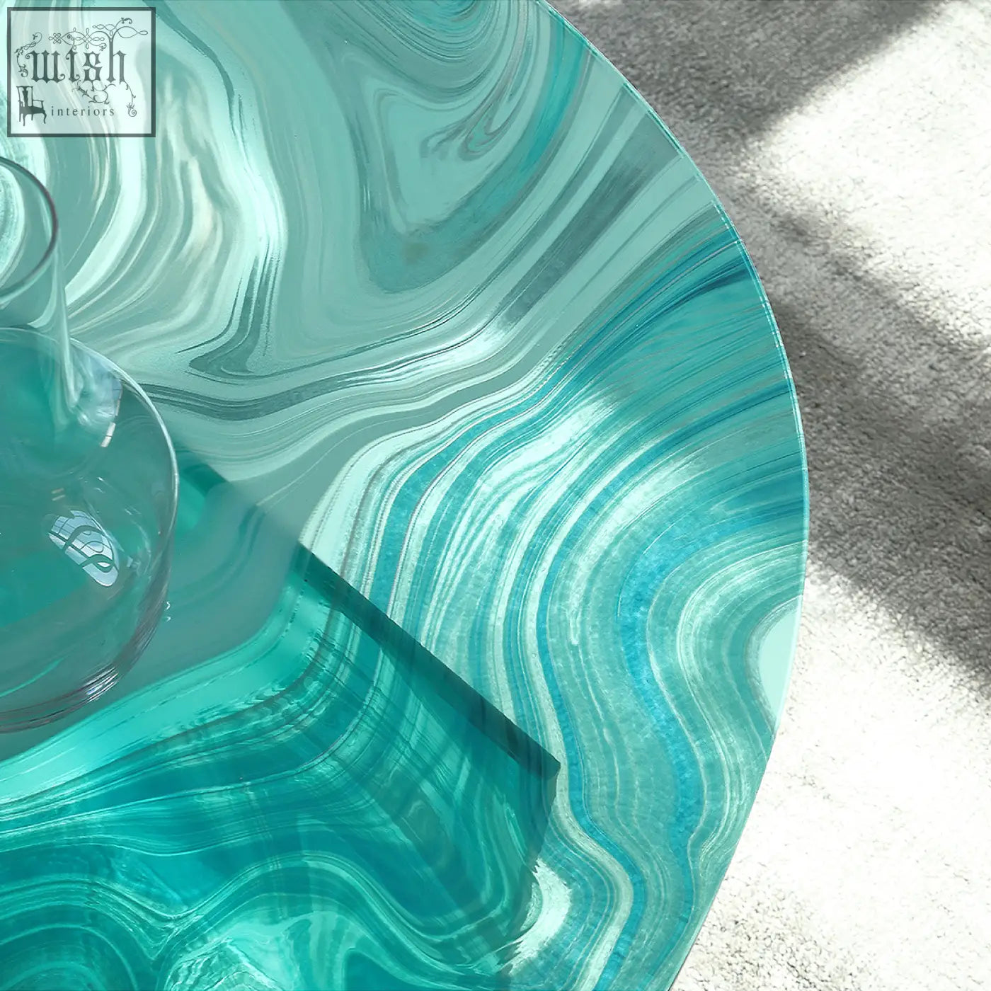 Leila glass coffee table in translucent turquoise with swirling marbled patterns perfect as a round nesting coffee table