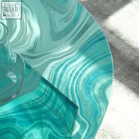 Leila glass coffee table in translucent turquoise with swirling marbled patterns perfect as a round nesting coffee table