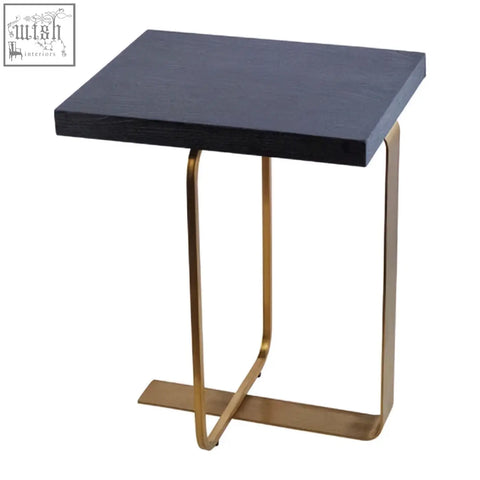 Black lena rectangular side table with gold base and curved metal legs in a modern finish