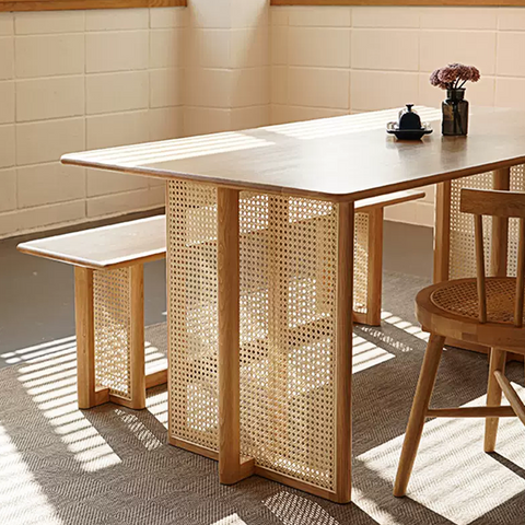 Leocadia solid wood dining table with light wood tabletop and woven cane solid wood legs for dining use