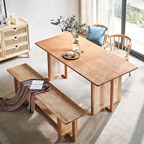 Light wood leocadia solid wood dining table with woven cane legs and sides perfect for solid wood dining rooms