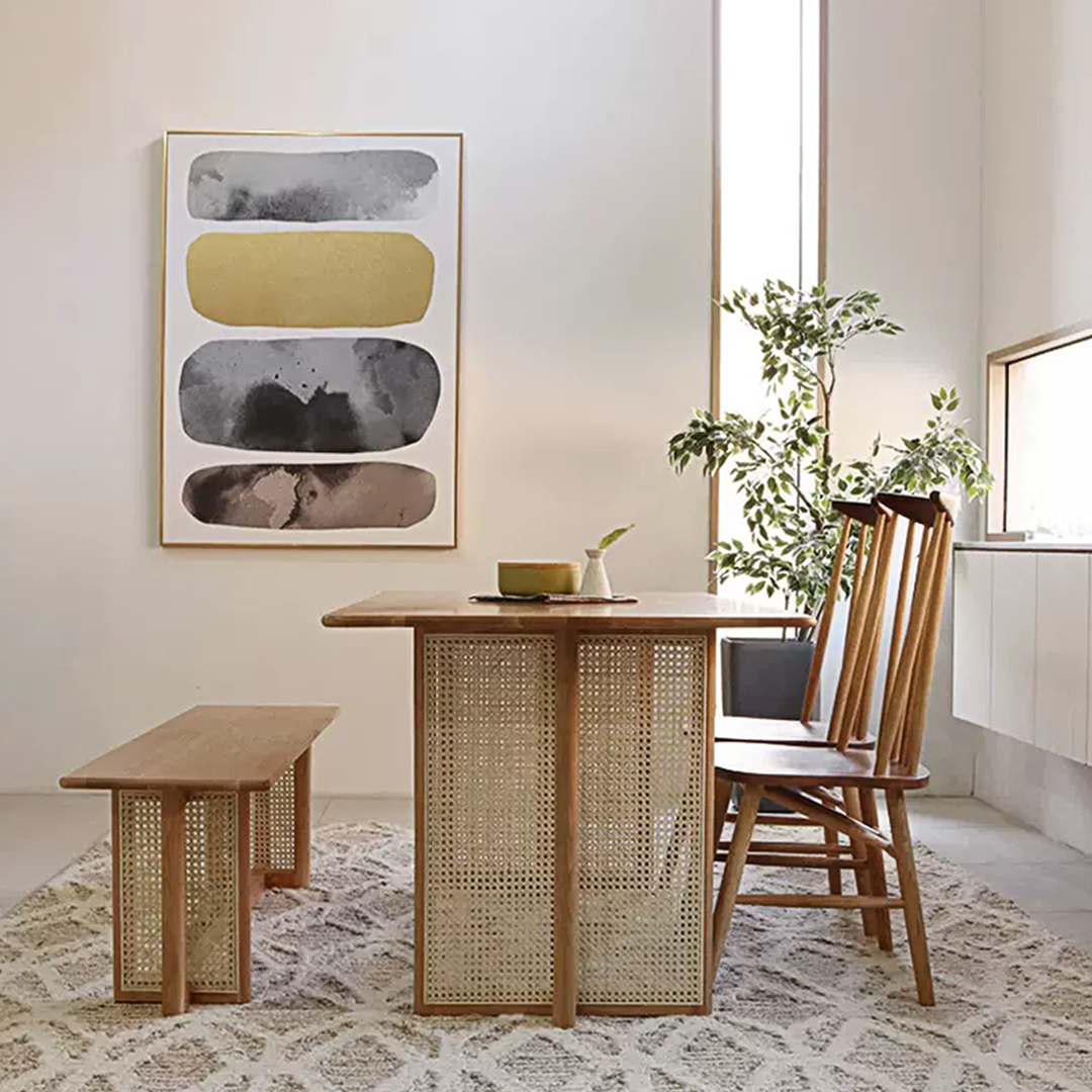 Leocadia solid wood dining table with light wood top and woven cane legs paired with matching bench minimalist design