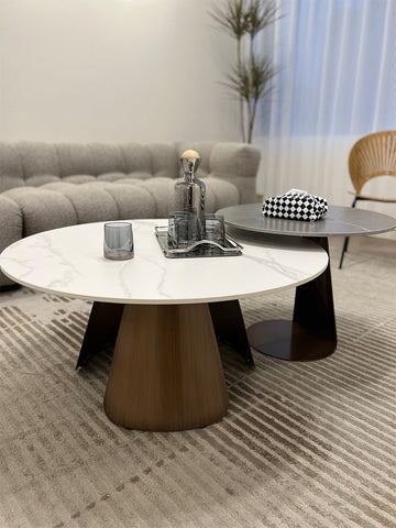 Modern round leonor nesting coffee table with white marble top and bronze tapered steel base perfect for living rooms