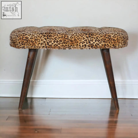 Leopard print deep button tufted bench with dark wood legs perfect for stylish seating in living spaces