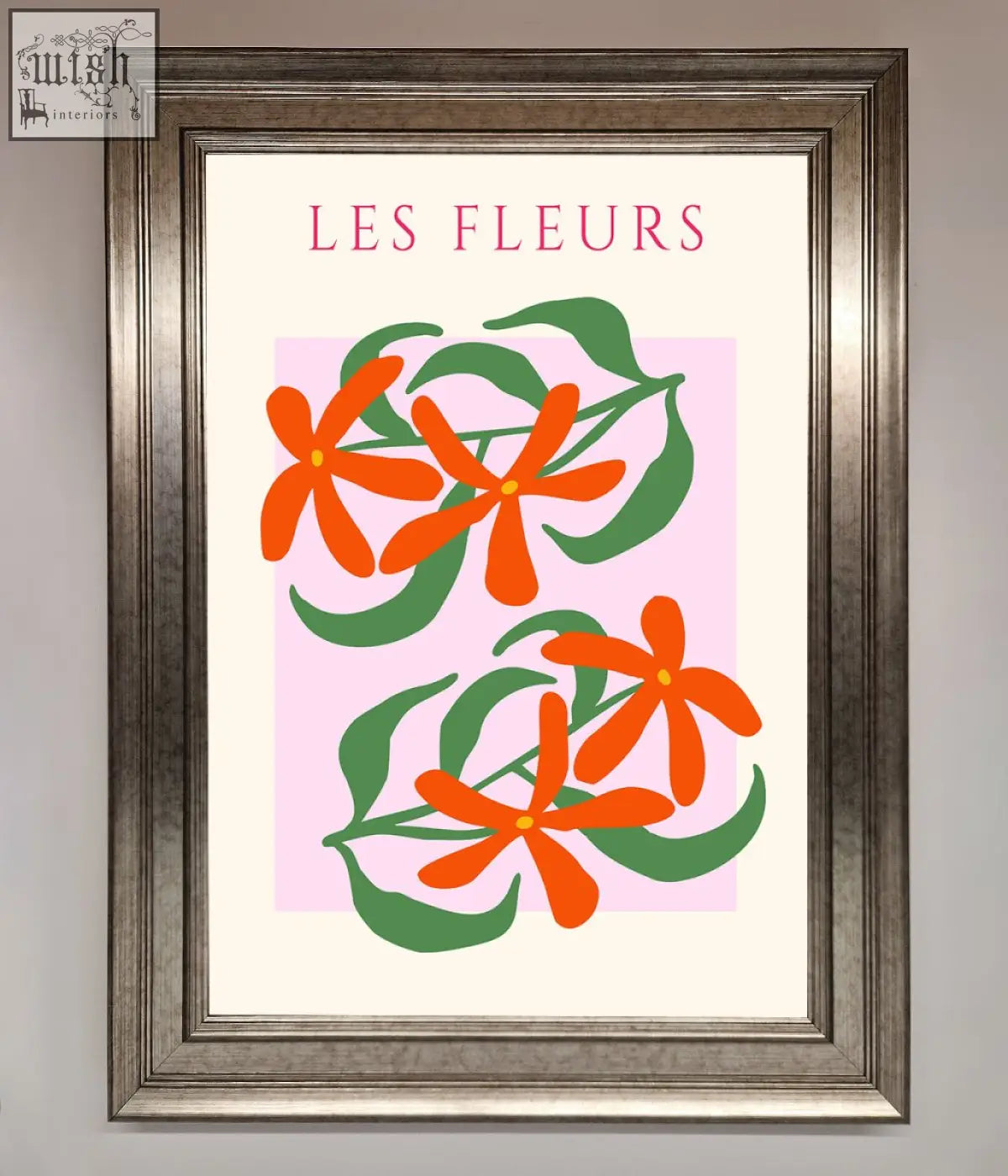 A les fleurs framed print featuring stylized orange flowers and green leaves on a soft pink background with elegant lettering