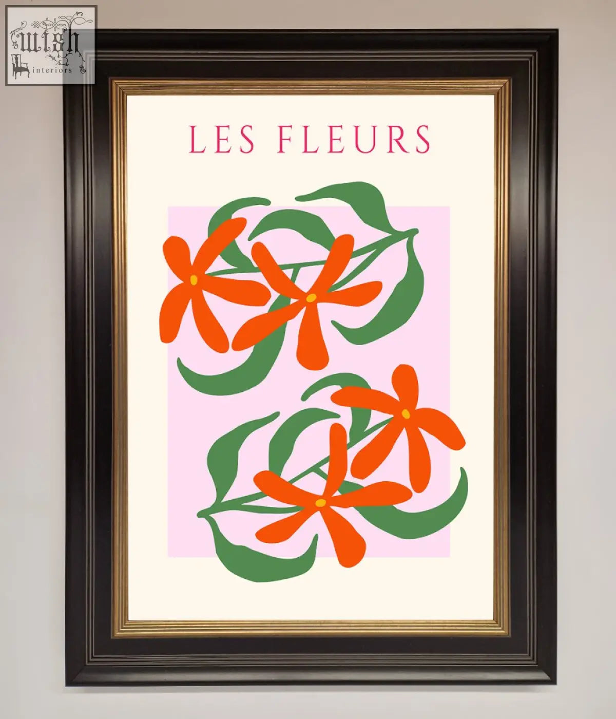 A les fleurs framed print featuring stylized orange flowers and green leaves on soft pink background with black gold frame
