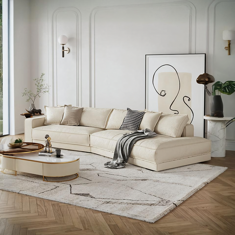Cream-colored lester four seater curved sofa with plush cushions and a sleek modern design for comfortable seating