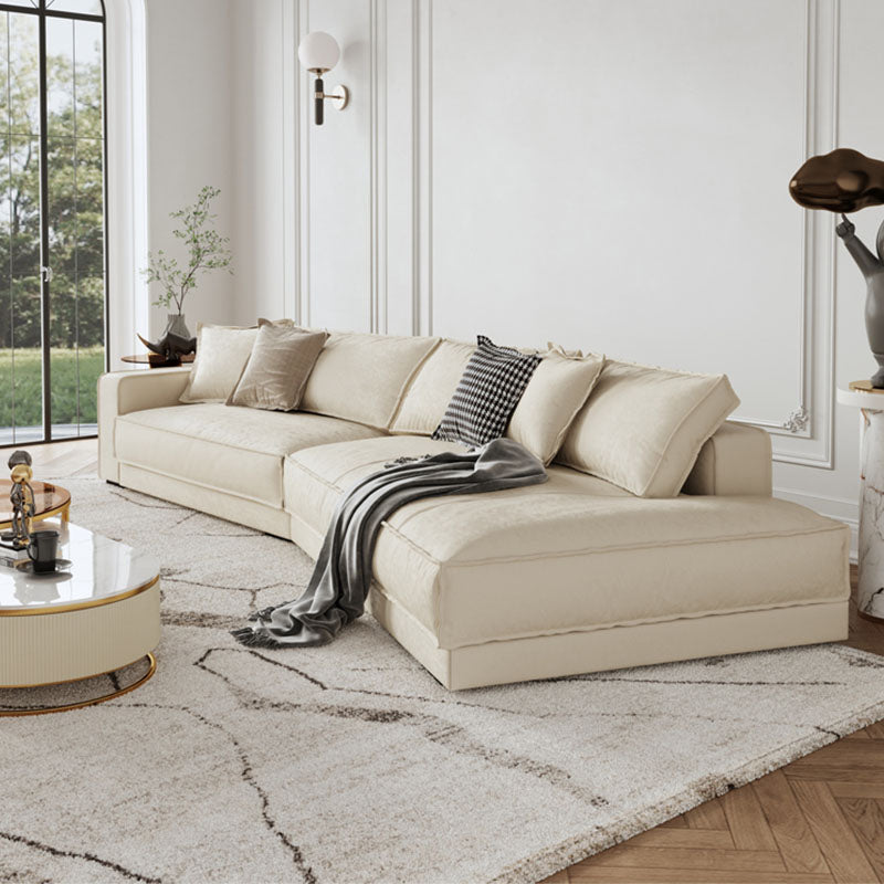 Cream-colored lester four seater curved sofa with plush cushions and sleek modern design perfect for living rooms